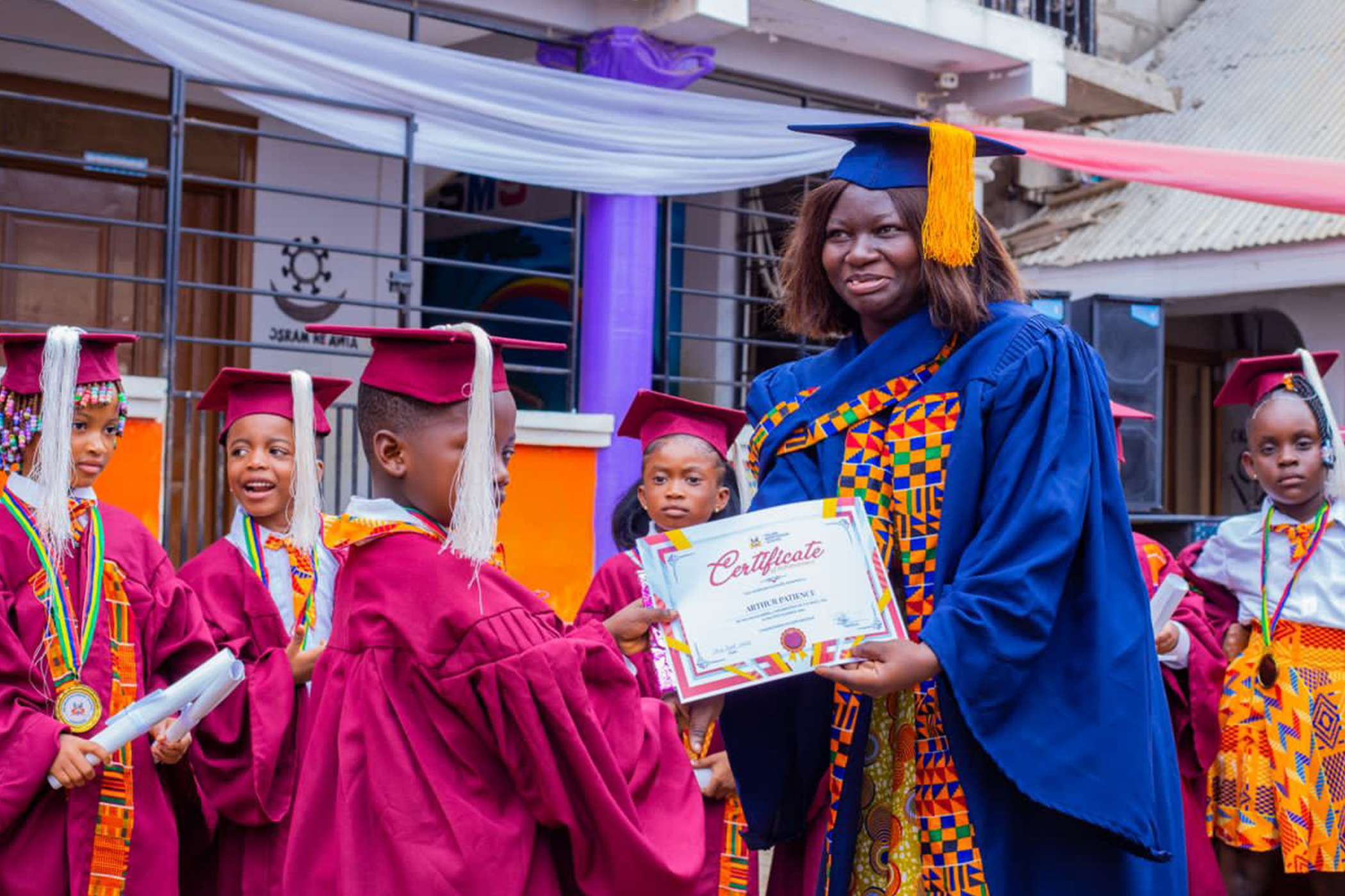 Graduation ceremony with teacher and students